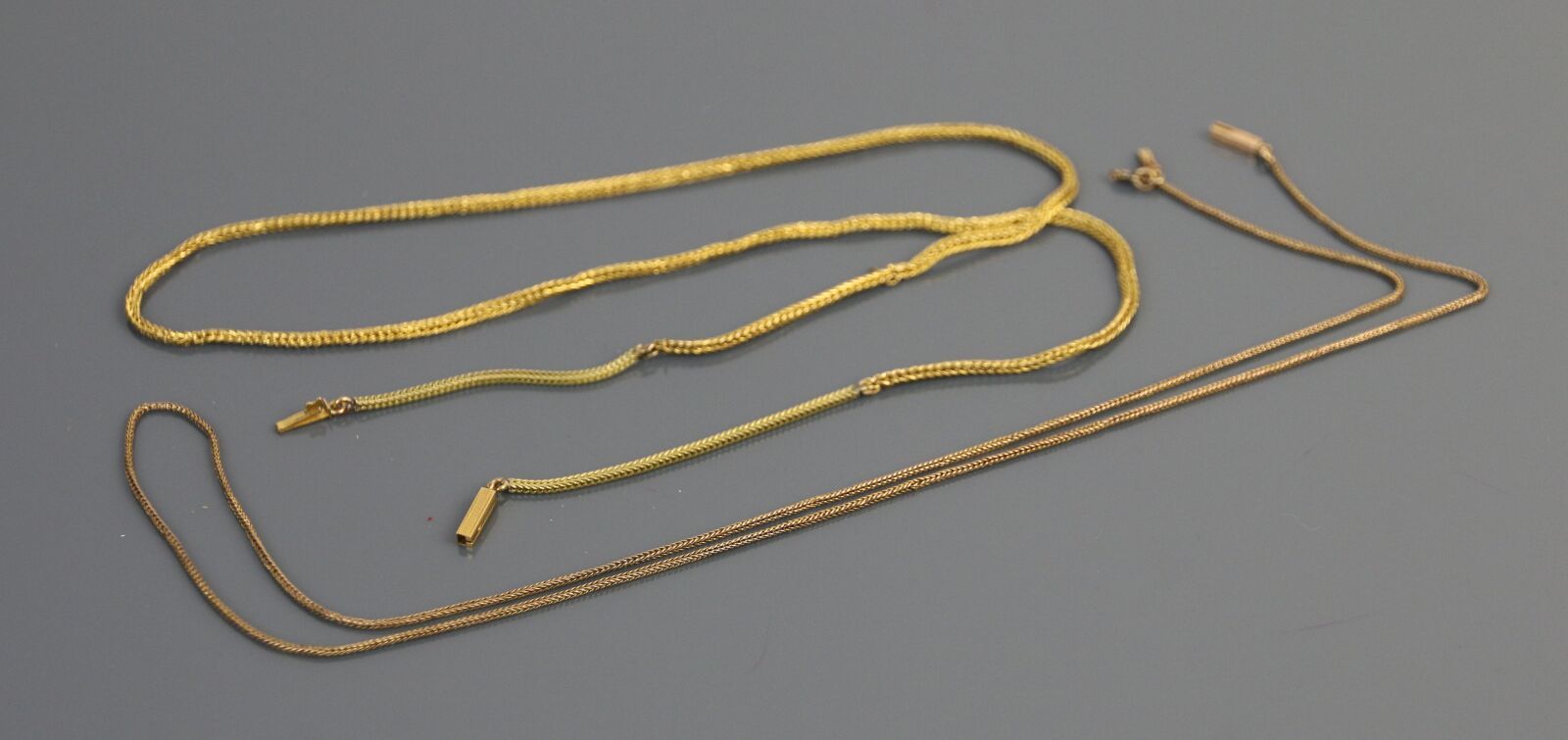 Null 两条链子，一条是750°/°的玫瑰金，另一条是750°/°的黄金，人字形链接，棘轮扣。

重量 : 9,1 g