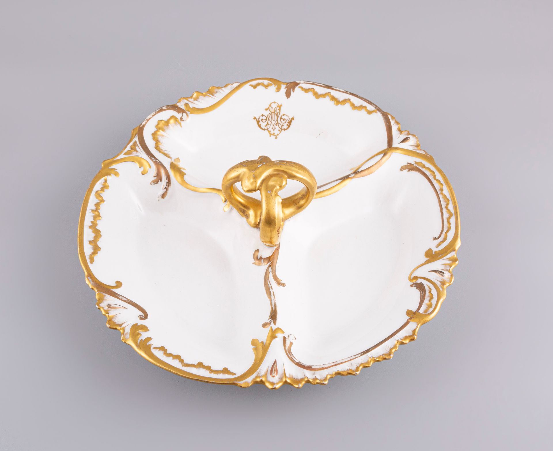 Null LIMOGES France. White porcelain hors d'oeuvre display stand with gilding.