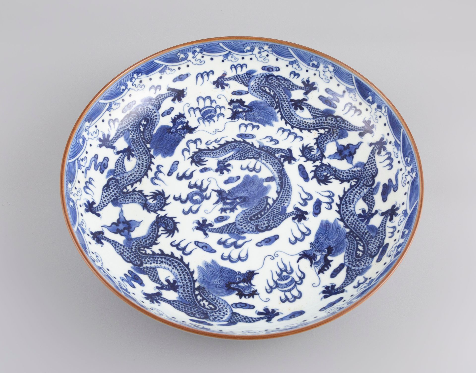 Null A Chinese porcelain bowl decorated with stylized dragons. Modern copy.