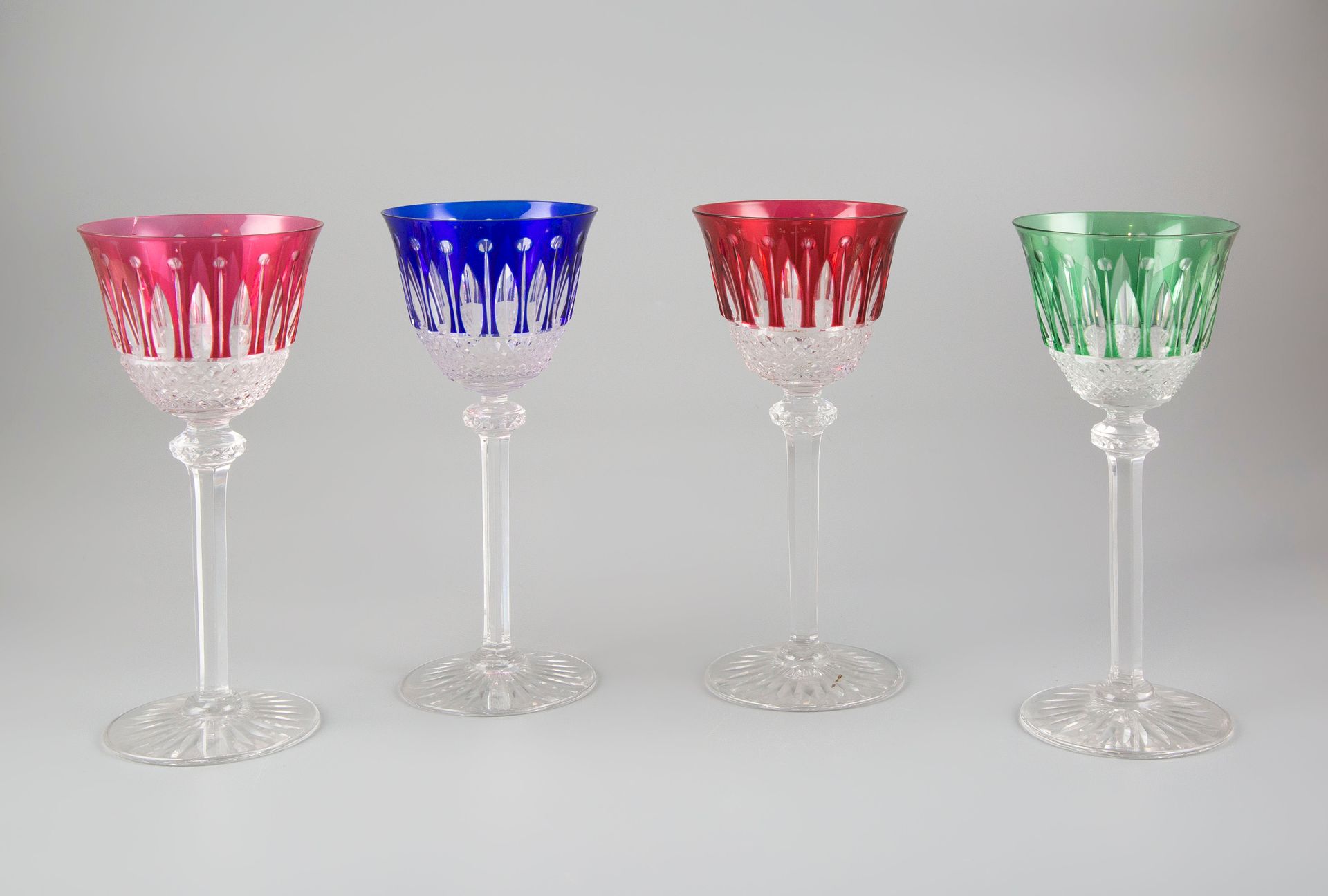 Null SAINT LOUIS France. Suite of twelve footed glasses in tinted crystal.