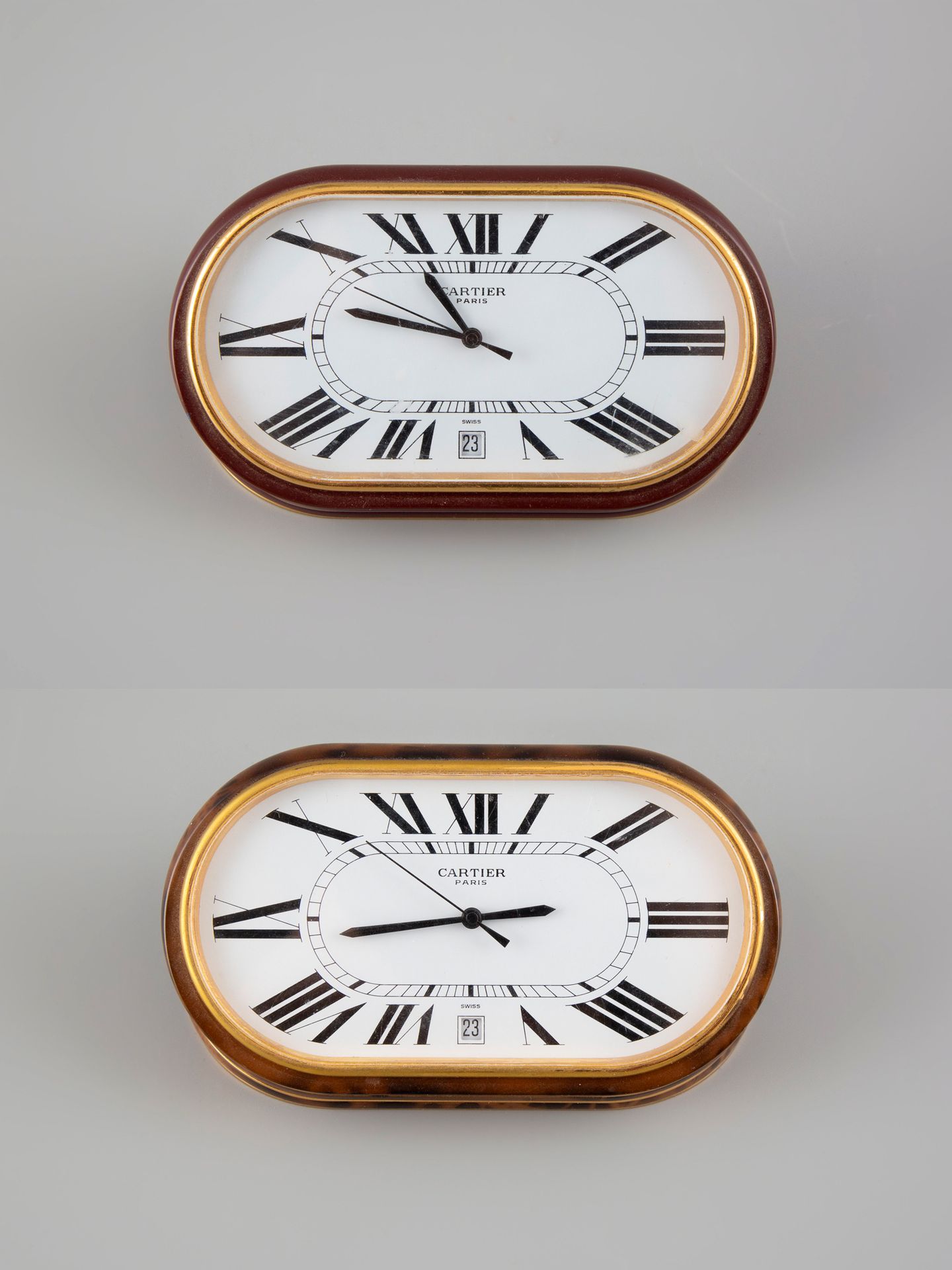 Null CARTIER. Two gilt metal and lacquer table clocks. Quartz movement. Sold as &hellip;