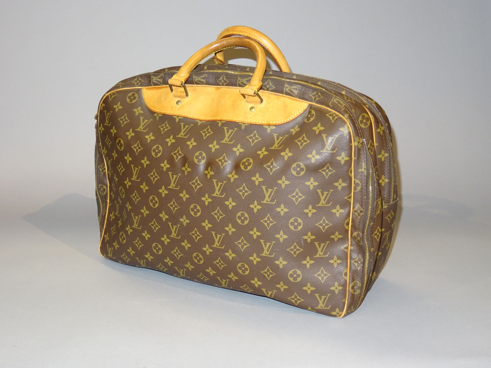 Louis VUITTON: Small leather and canvas travel bag with …