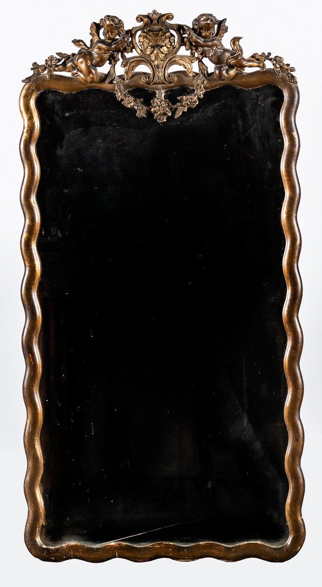 Null Miroir dans un encadrement en bois et stuc de forme ondulée surmonté d'un f&hellip;