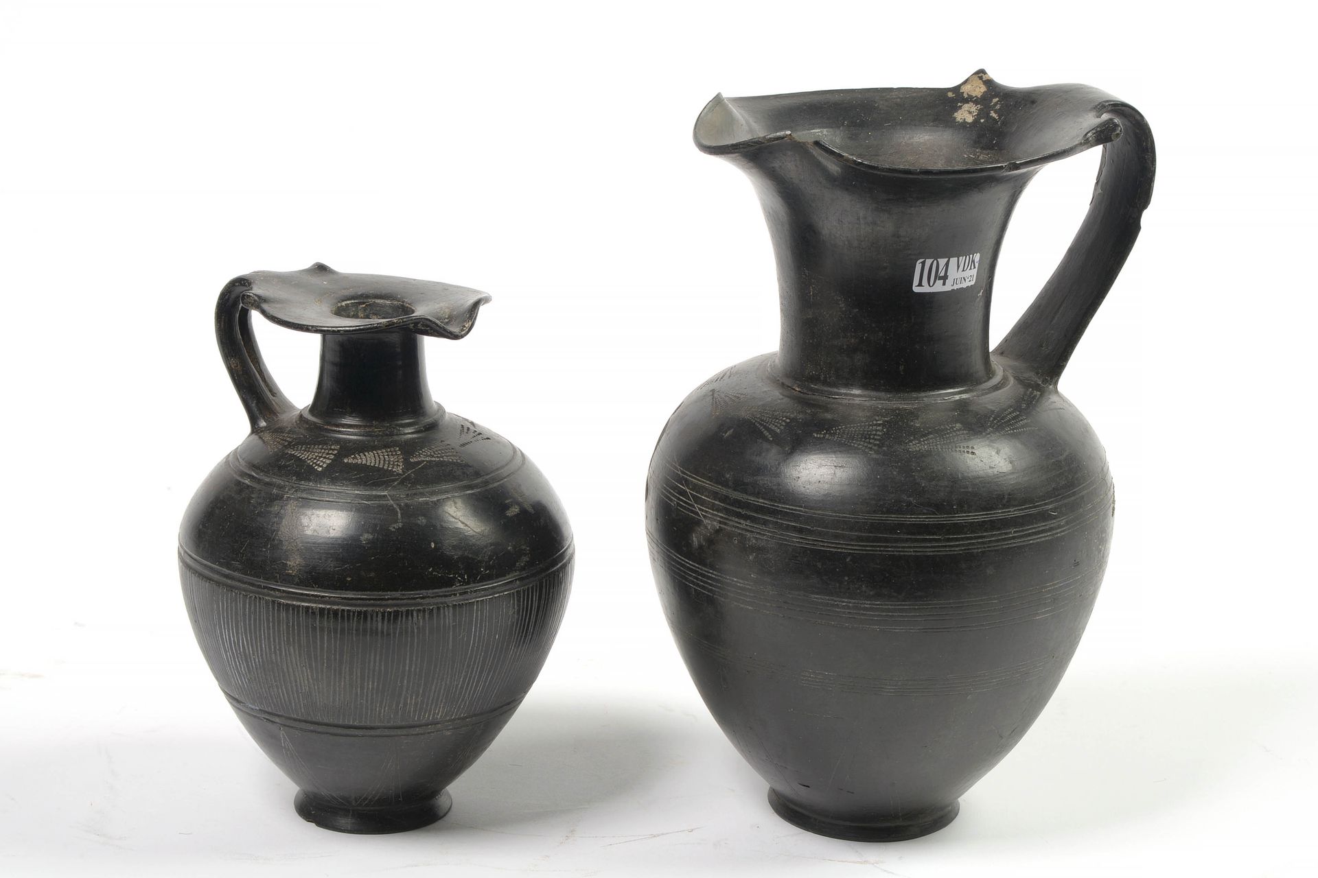 Null Two black glazed terracotta pots with incised geometrical decoration. Work &hellip;