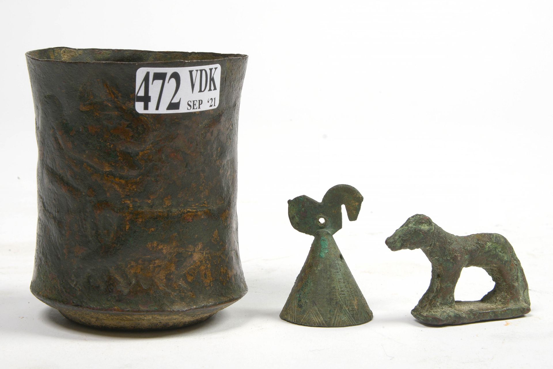 Null Set of three bronzes including: a repoussé cup decorated with "Winged Griff&hellip;