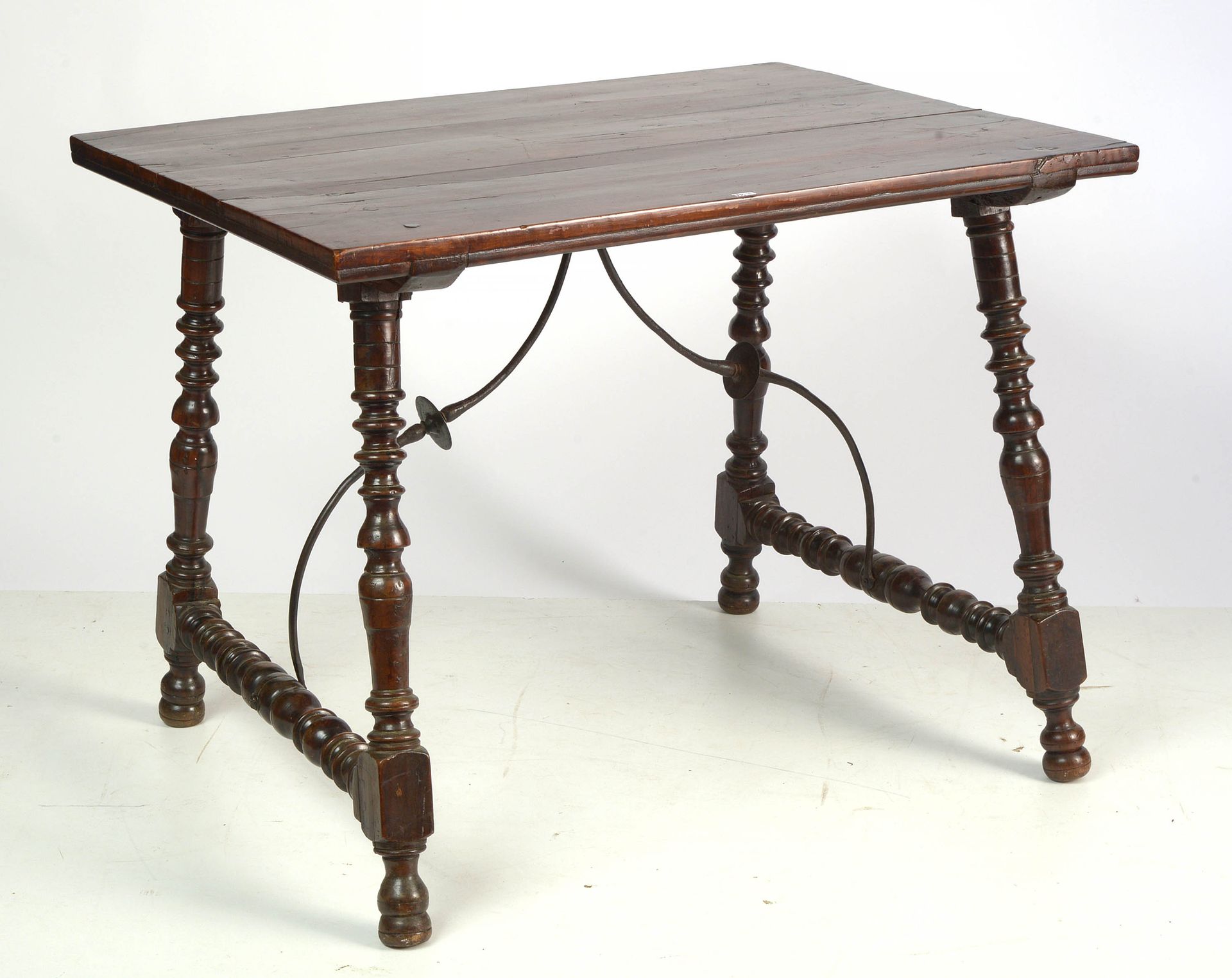 Null 胡桃木的小长方形桌子，在带有锻铁支杆的栏杆底座上。西班牙的工作。年代：部分17世纪。Dim.:+/-101,7x77x76,5cm.