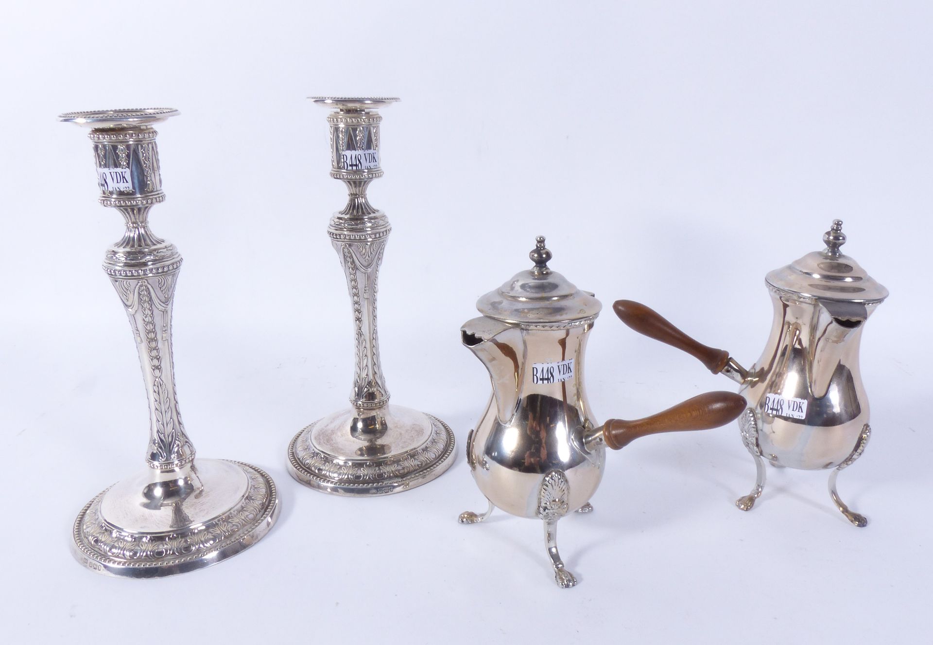 Null Pair of candlesticks and a pair of silver tripod pourers.
