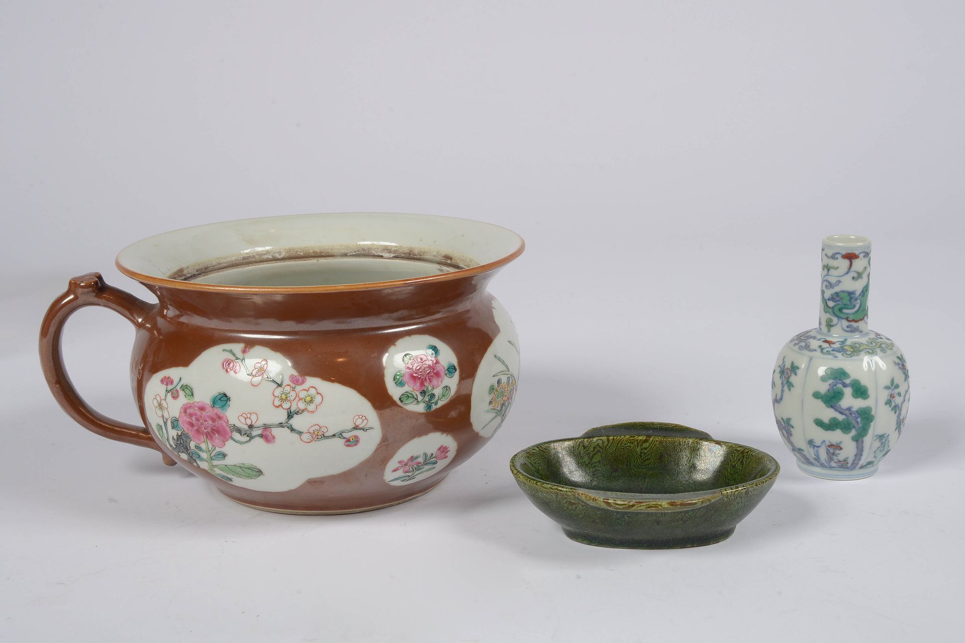 Null 一套三件：唐代双柄小陶盘，绿色玑镂釉。年代：15世纪。一件 "Capucin "瓷器室内壶。一件 "Doucaï "珐琅彩的小型多色瓷瓶，带有植物装饰&hellip;
