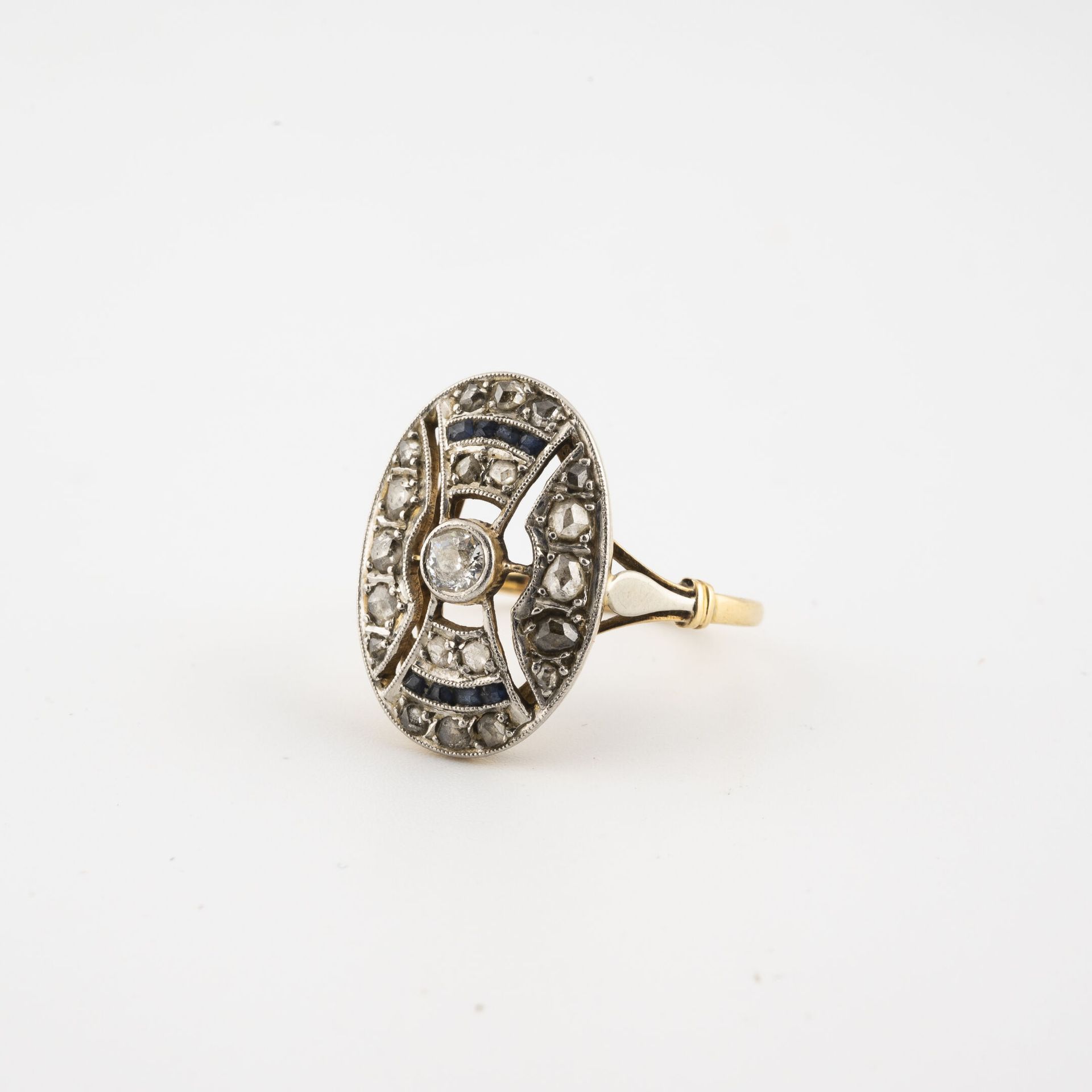 Null 黄白金(750)戒指，镂空椭圆形表圈，以老式切割钻石为中心，密镶小型玫瑰切割钻石和校准蓝宝石，采用轨道镶嵌。

毛重：3克。- 手指大小：49。

刮&hellip;