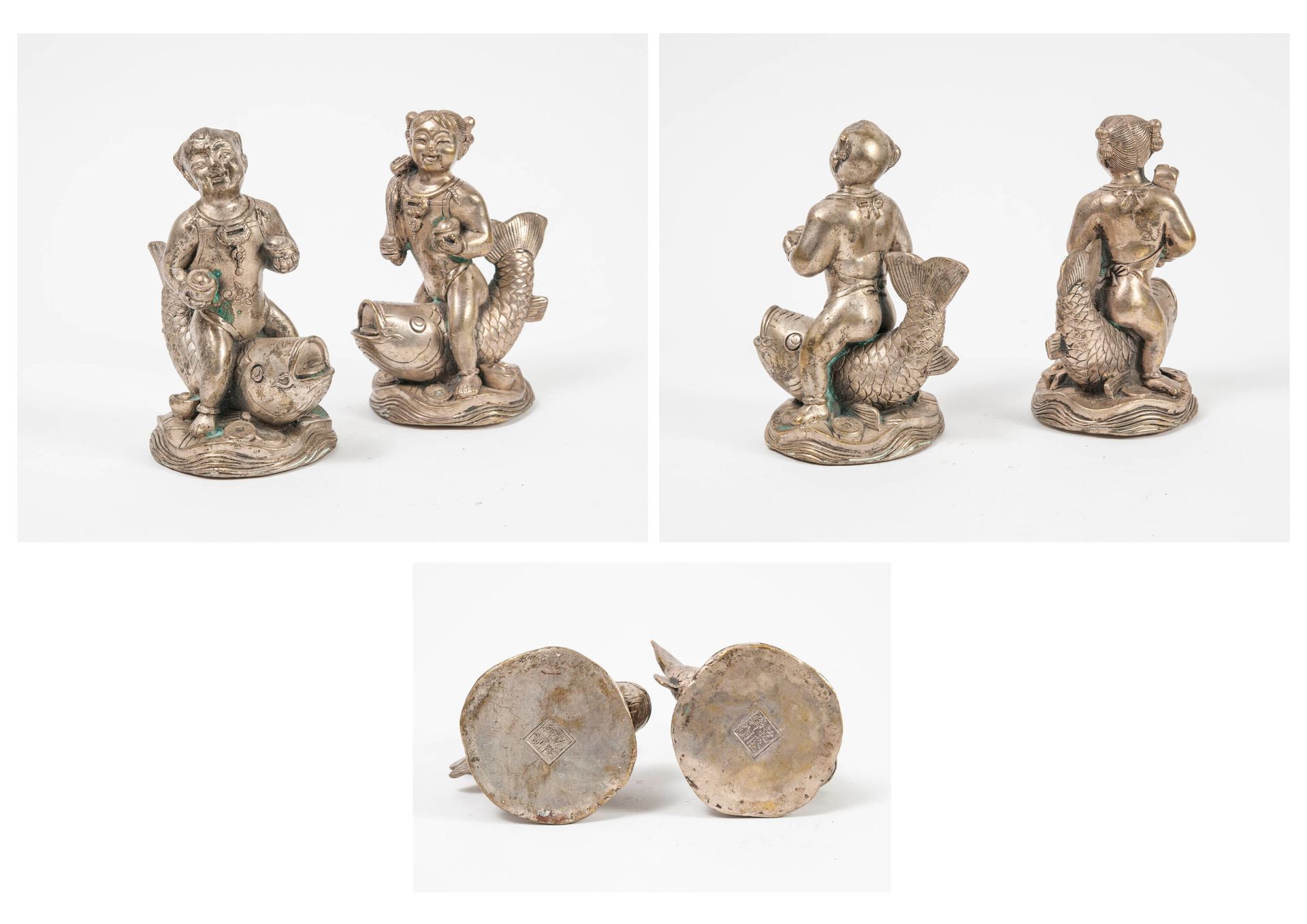 CHINE, XXème siècle Girl and boy each riding a carp. 

Statuette in silver plate&hellip;