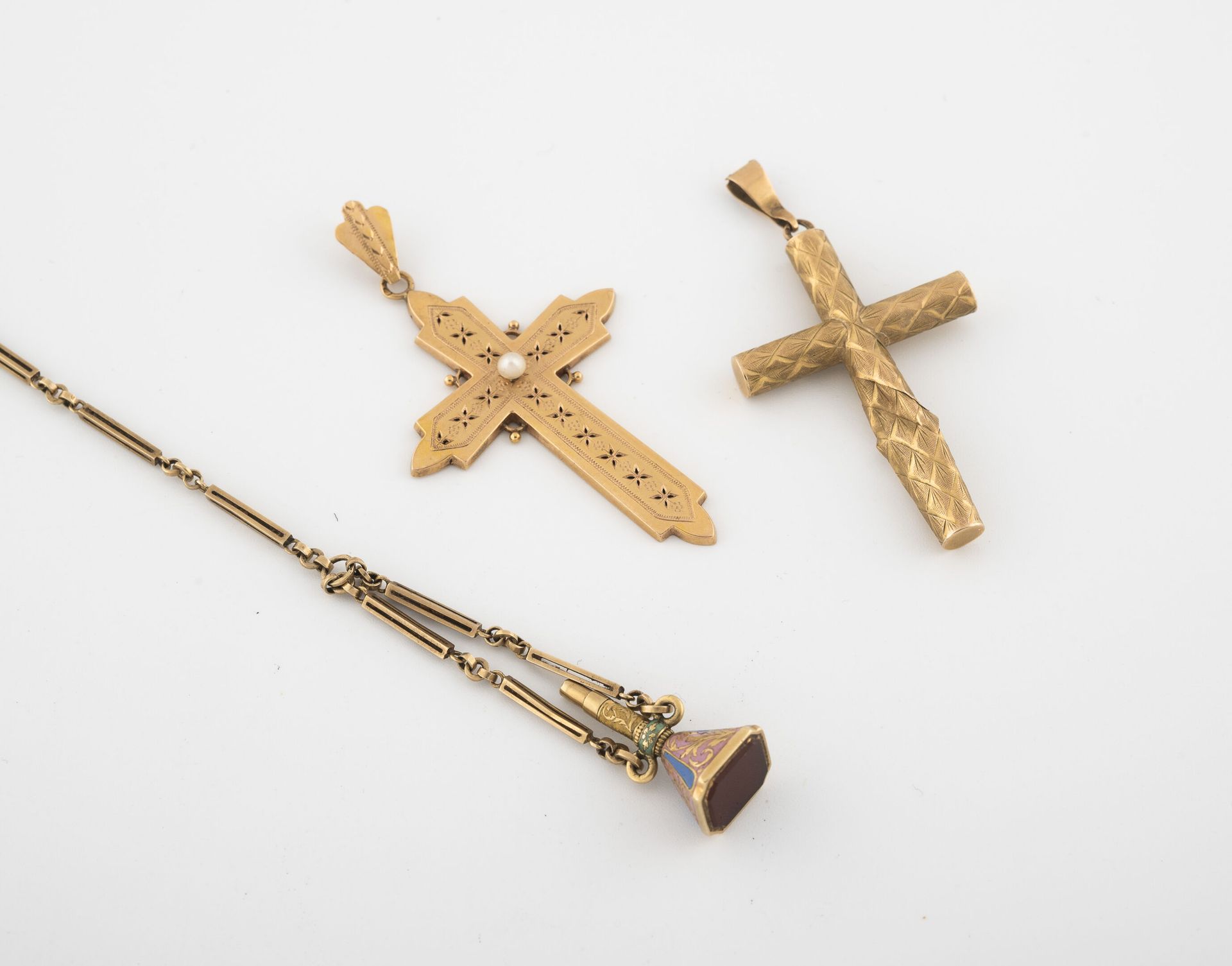 Lot comprenant : - Two cross pendants in yellow gold (750), one decorated with a&hellip;