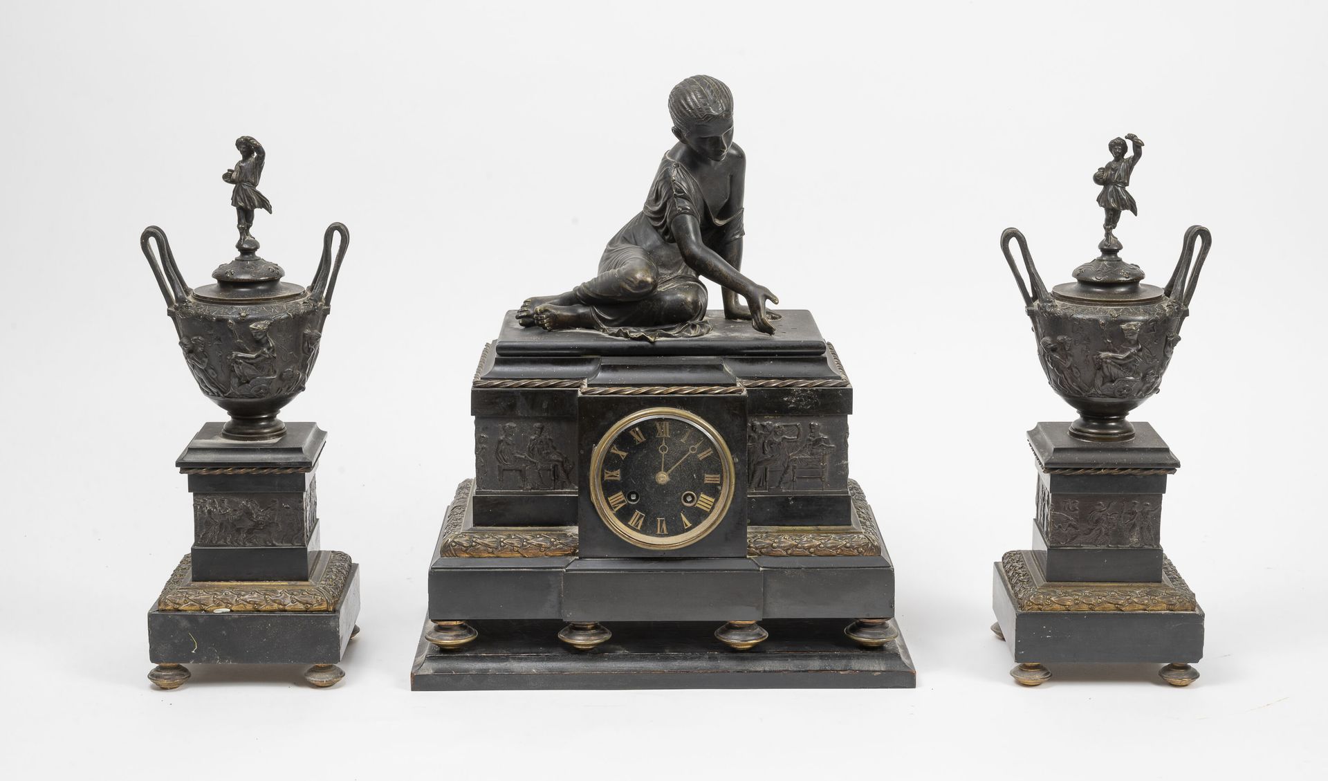 FRANCE, fin du XIXème siècle 一套镀铜或鎏金的青铜和黑色大理石壁炉，包括:

- 一个带有骨质播放器的时钟，上面装饰着仿古风格的人物&hellip;