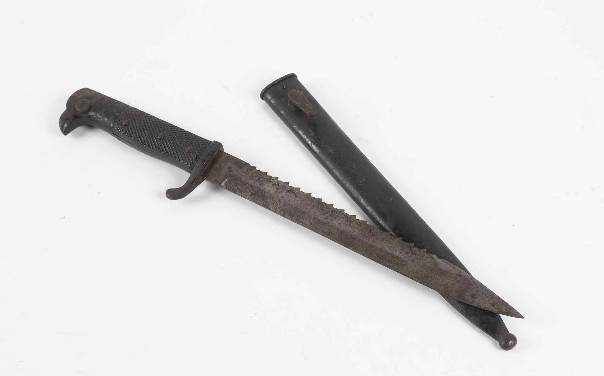 Null 德国的锯齿刺刀。

钢制手柄，带有方形成分的插入物。

锯齿状的刀片。

金属刀鞘。

氧化作用。

长：37.5厘米。