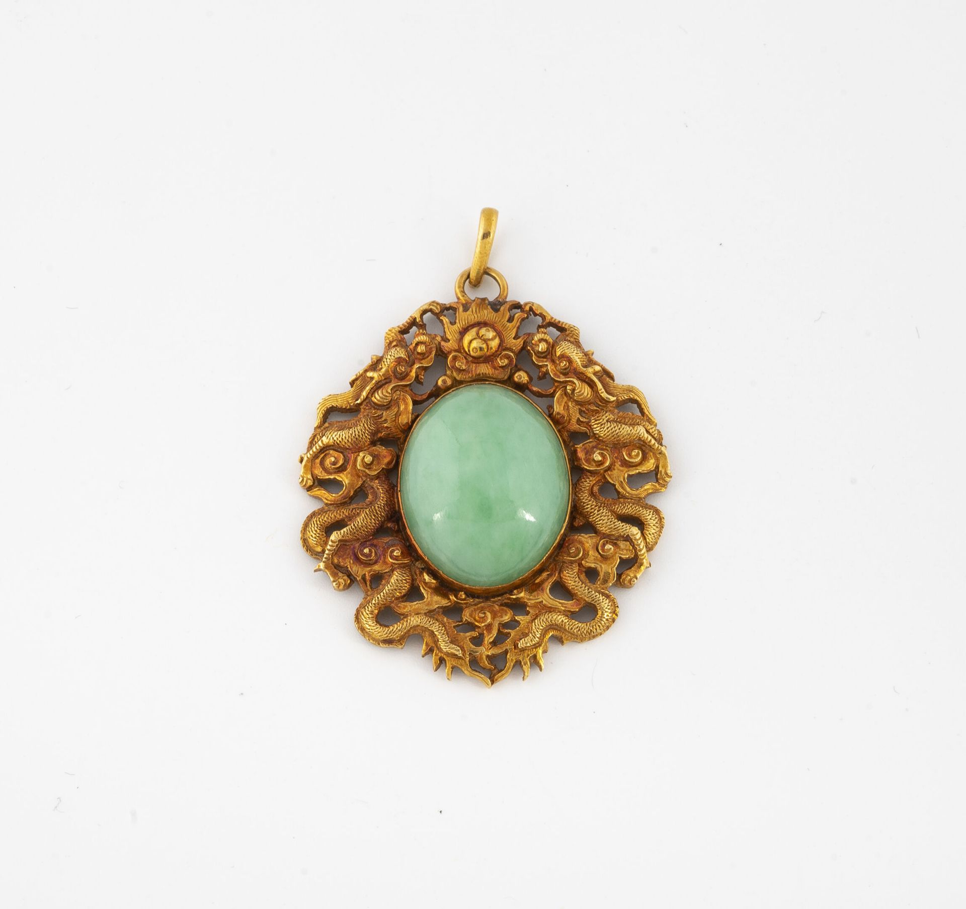 CHINE Yellow gold (750) pendant centered on an oval cabochon of jadeite in a clo&hellip;