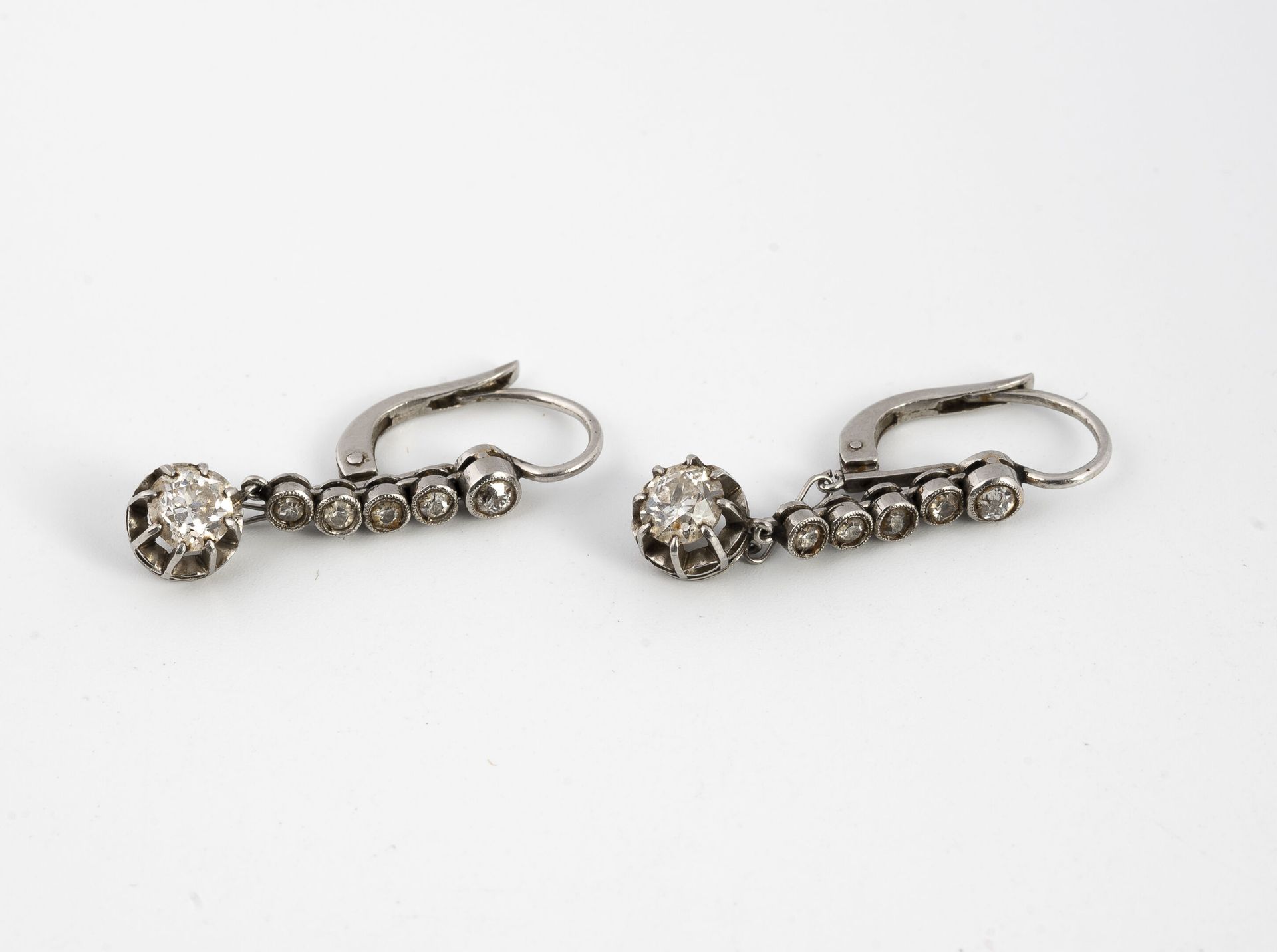 Null Pair of platinum (850) earrings set with a line of small old-cut diamonds i&hellip;