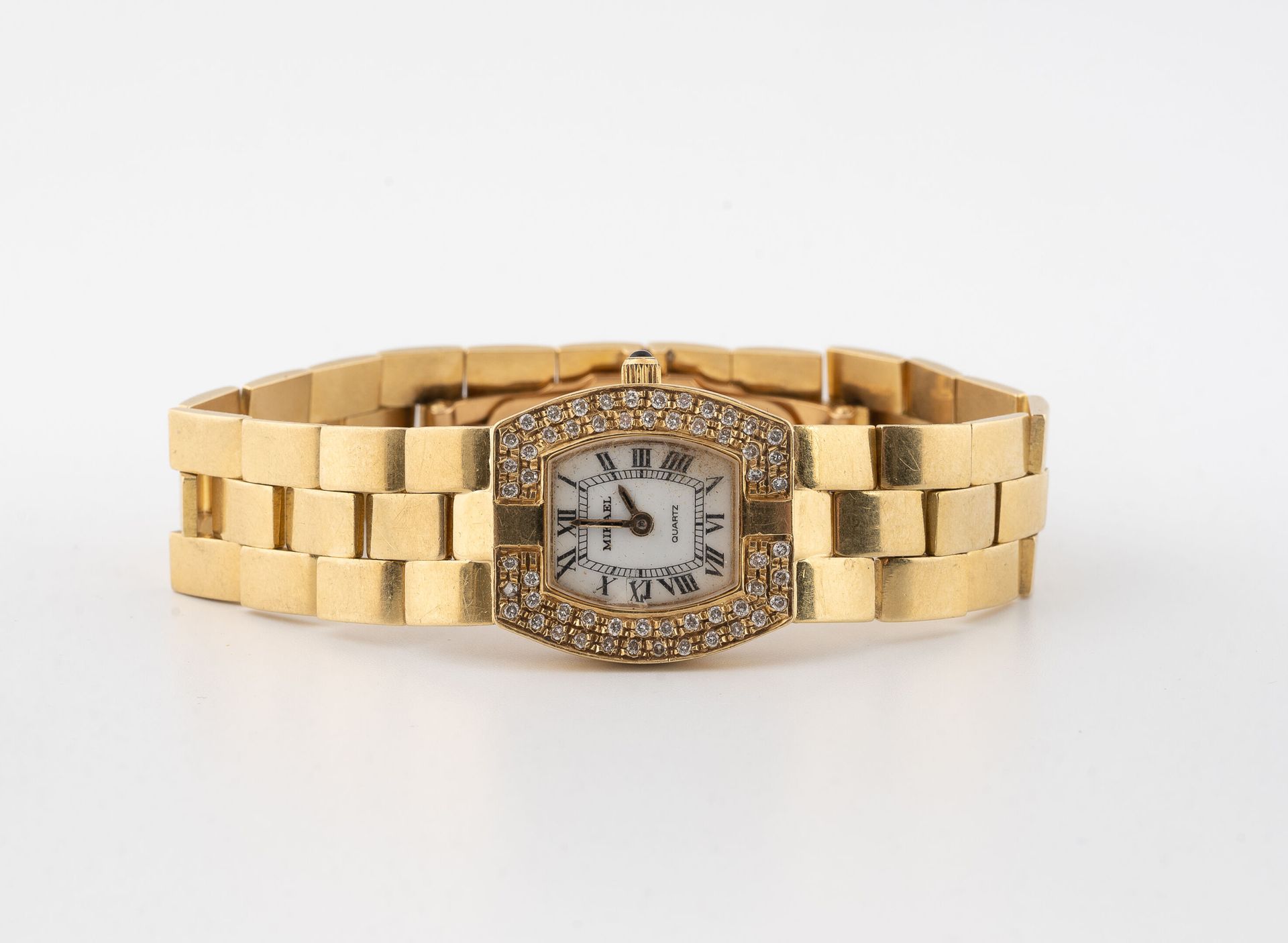 MIKAEL Lady's wristwatch in yellow gold (750).
Barrel case, bezel paved with sma&hellip;