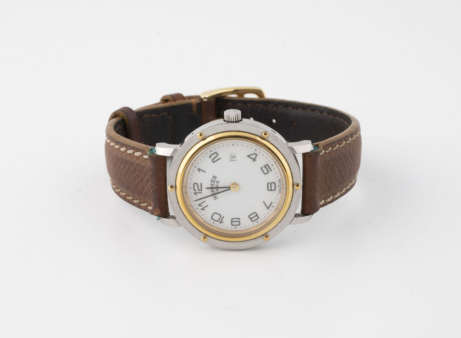 HERMES Paris, Clipper Steel and gold metal bracelet watch.
Round case. 
White en&hellip;