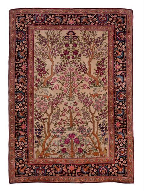 IRAN, XXème siècle 

Tapis en laine polychrome à décor d'arbres et chargé de fle&hellip;