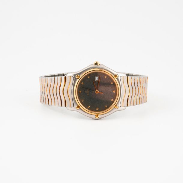 EBEL 

Montre bracelet d'homme en acier et métal doré. 

Boîtier rond bordé de v&hellip;