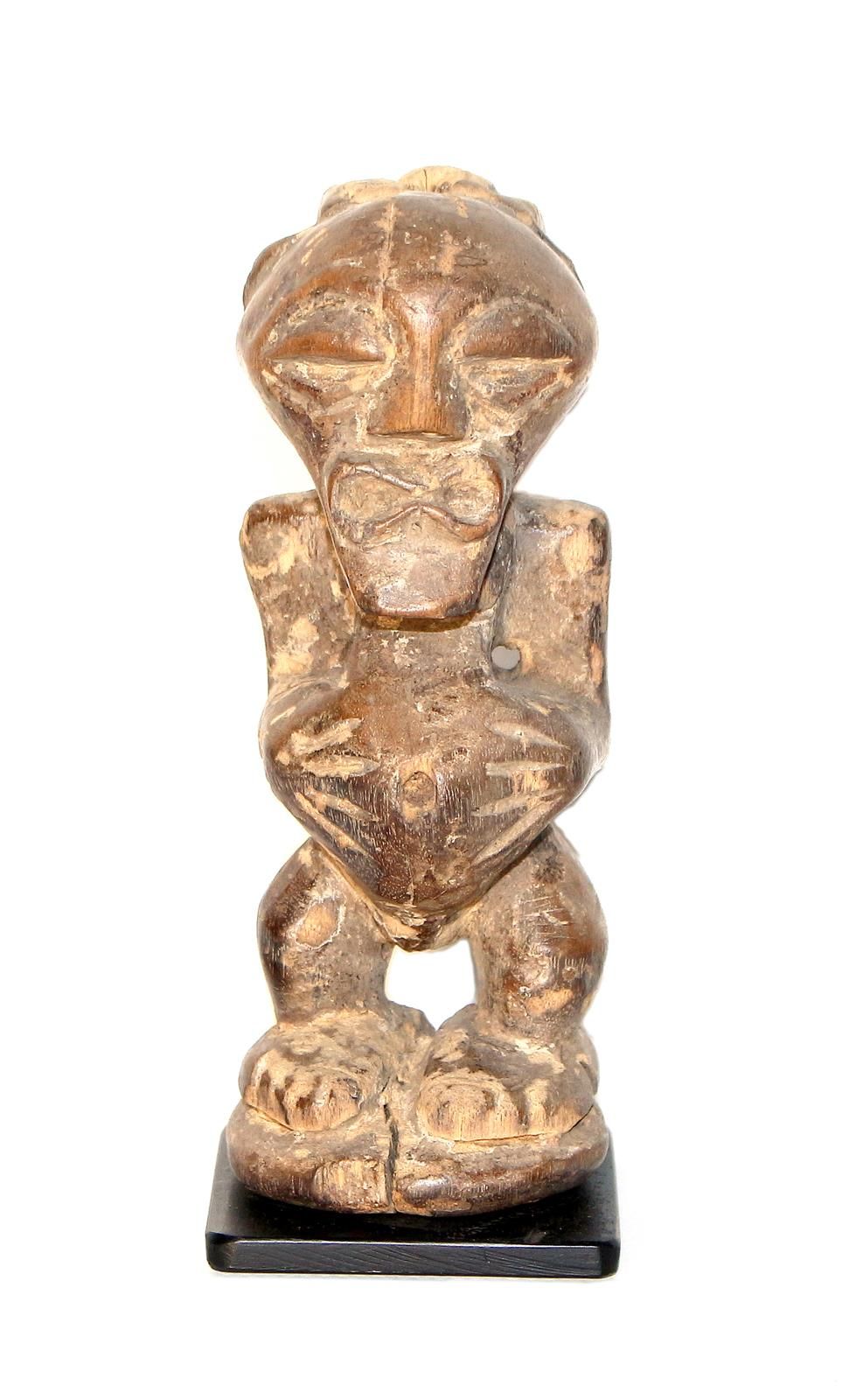 Songye, Kongo. Small magic figure of Songye, holding his belly. Wood. 15 cm. D