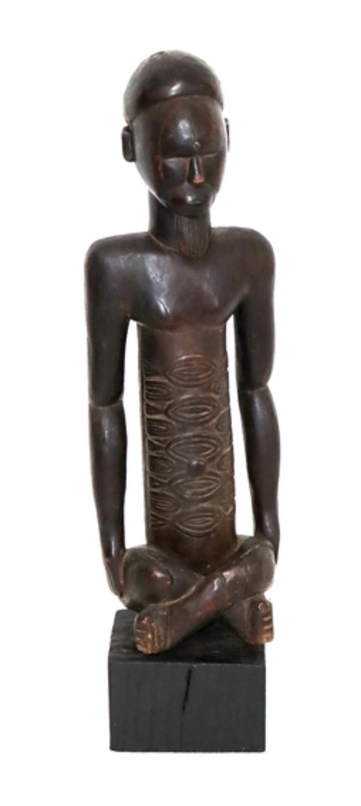 KONGO Sitting male figure with closed eyes. Hard wood with dark patina. 49,5 cm.&hellip;