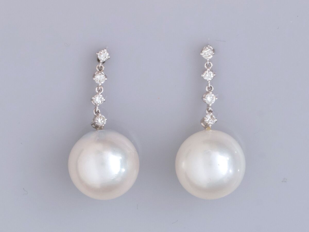 Null 一对18K白金耳环，每只耳环都镶有一排四颗明亮式切割钻石和一颗南洋养殖珍珠，直径12.5/13毫米。长度： 2.8 cm