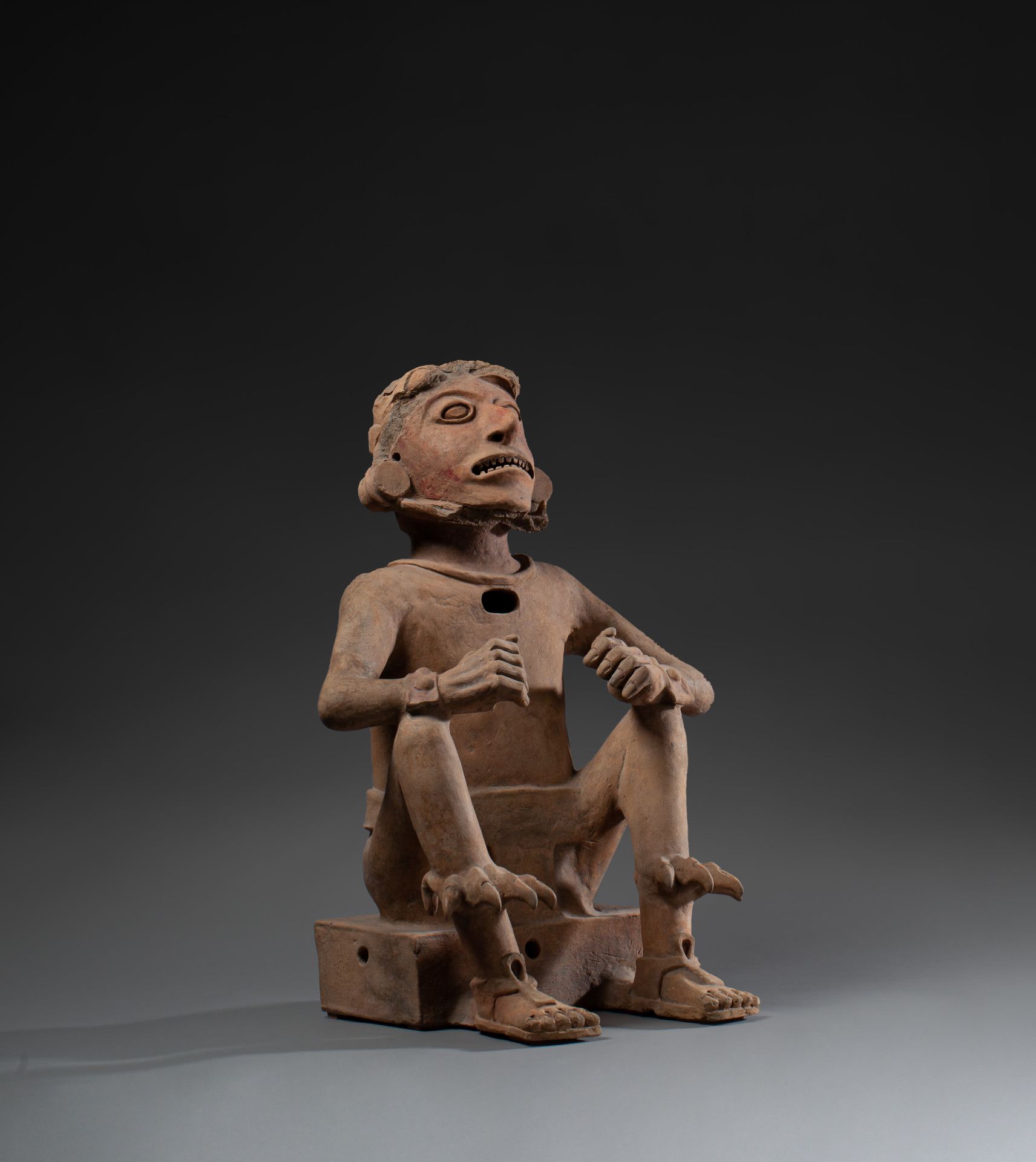 *Sculpture anthropomorphe 
depicting a deity seated on a bench, face up, legs be&hellip;