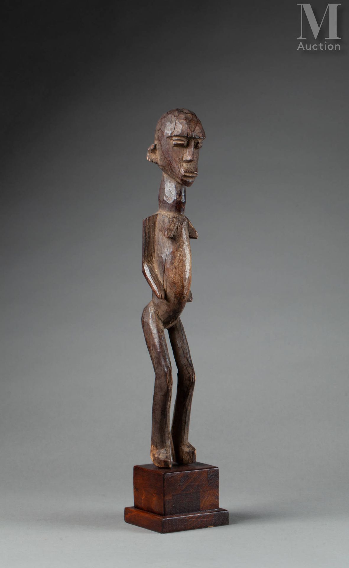 Statue féminine (Lobi) présentée nue debout, les genoux légèrement fléchis. Son &hellip;