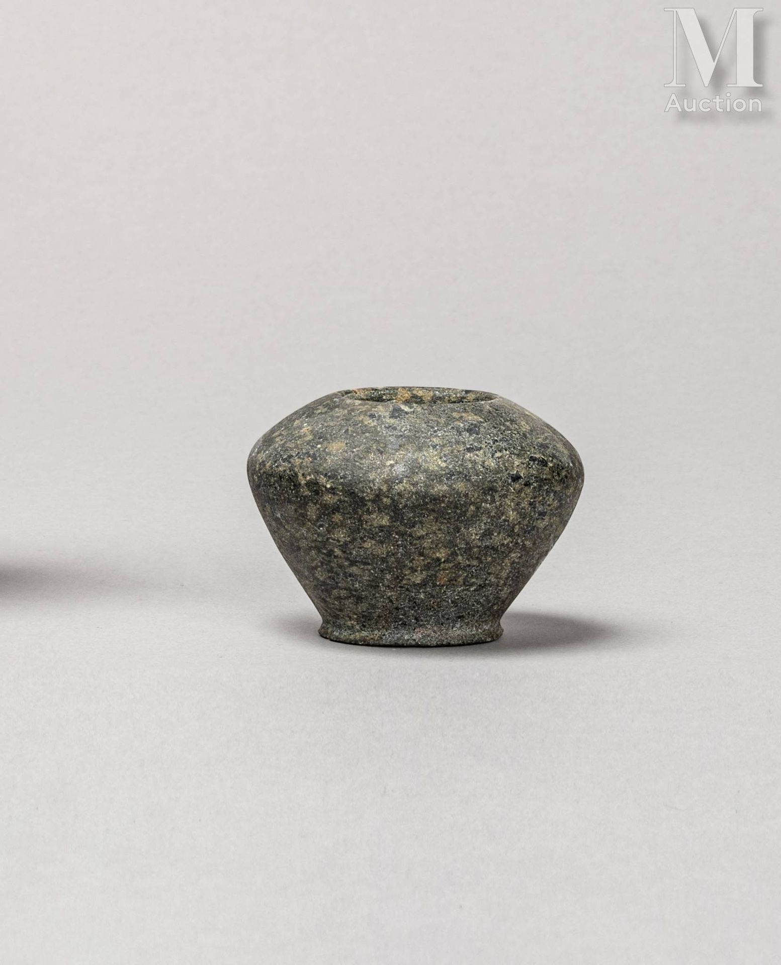 Petit vase with projecting discoid foot and crushed globular body.
Diorite. Mino&hellip;
