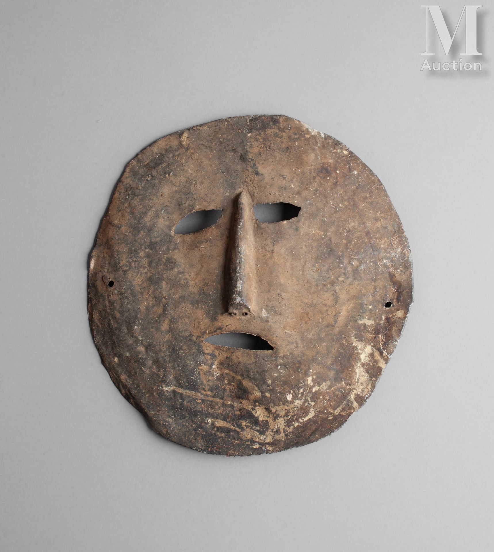 Masque applique Cut and hammered metal, marks of use and time 
Nepal
24 cm