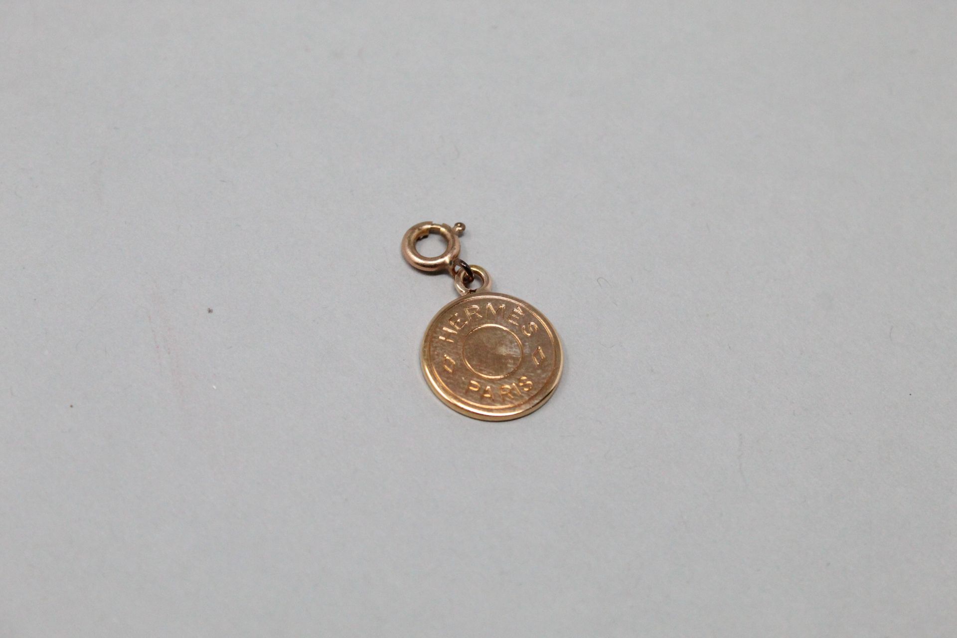 Null HERMES Paris

Pendentif de forme circulaire en métal doré, portant l'inscri&hellip;