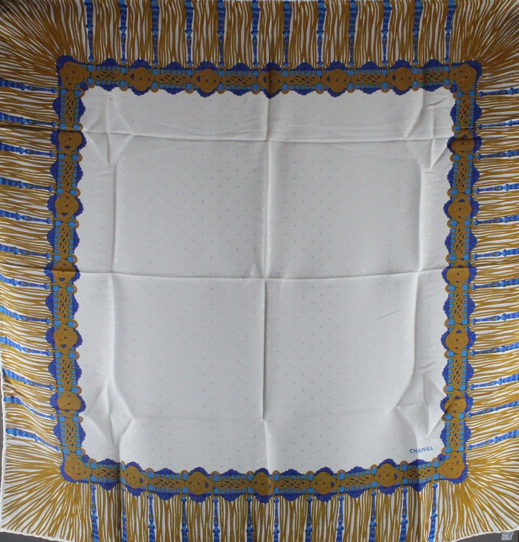 Null 香奈儿

白色丝绸方块，有蓝色和金色的门楣，签名。

84x84 cm - 在其签名的小袋中 - 使用状况。
