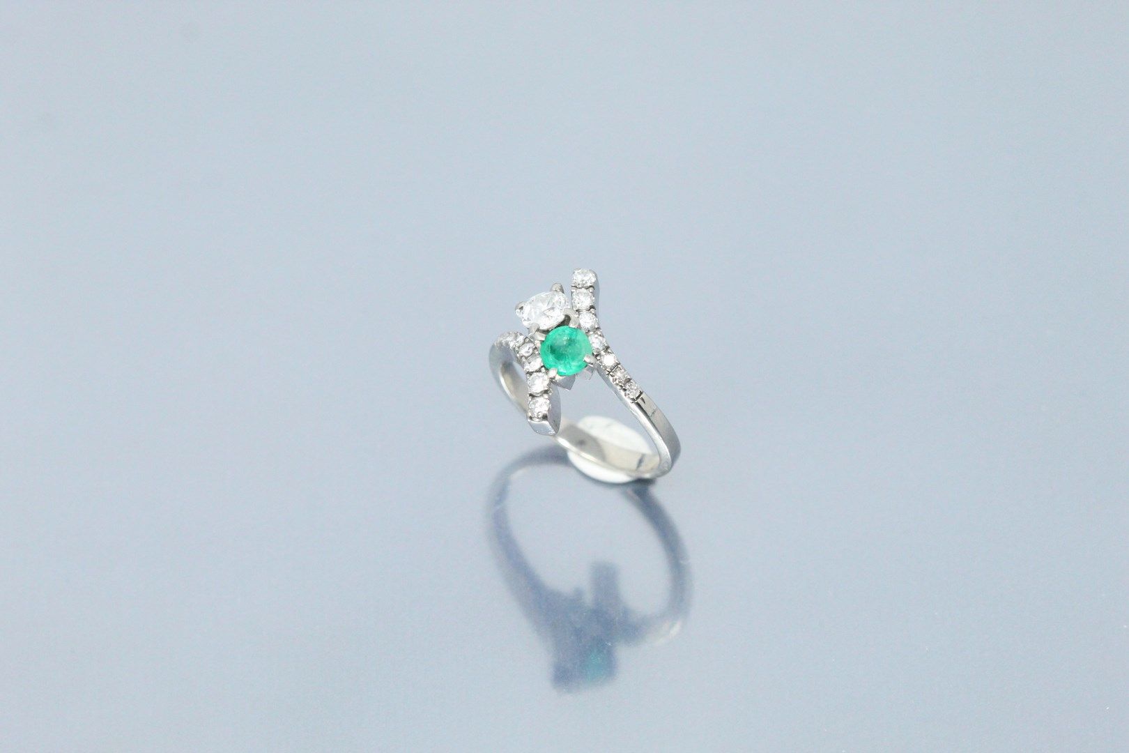 Null 18K（750）白金戒指，在两个镶有明亮式切割和8/8切割钻石的阿拉伯式图案之间，镶嵌了一颗圆形祖母绿和一颗老式切割钻石。

手指大小：57 - 毛重&hellip;