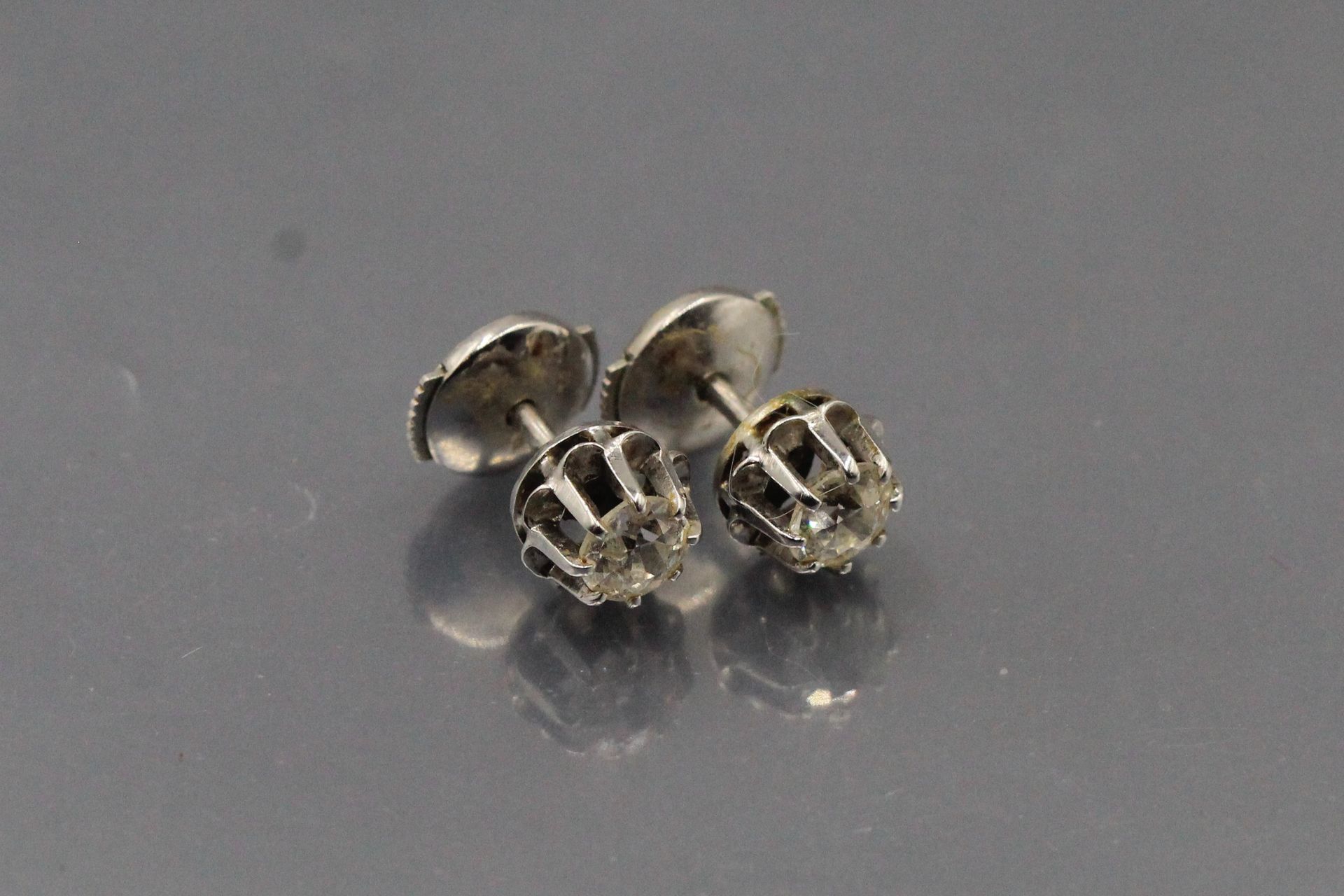 Null Pair of 18k (750) white gold and old cut diamonds studs. 

Marked with an e&hellip;