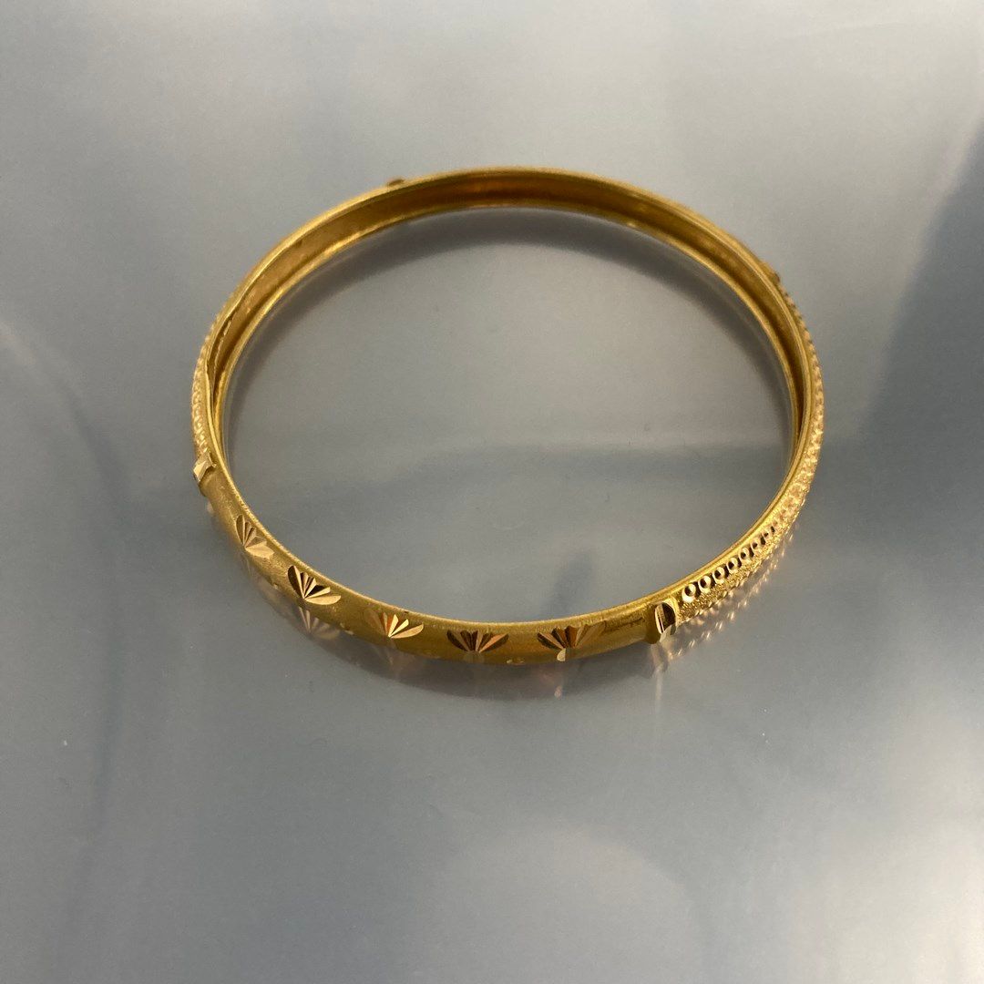 Null Rigid bracelet in 18K (750) yellow gold engraved with a geometrical design.&hellip;