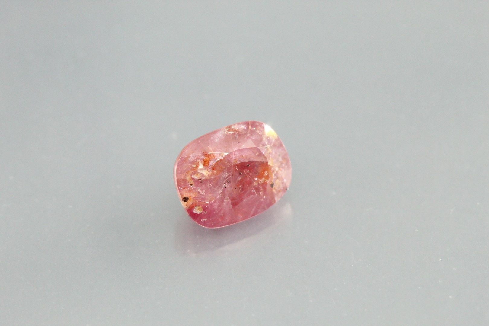 Null Pink sapphire cushion on paper.

Africa. 

Weight: 2, 06 cts.