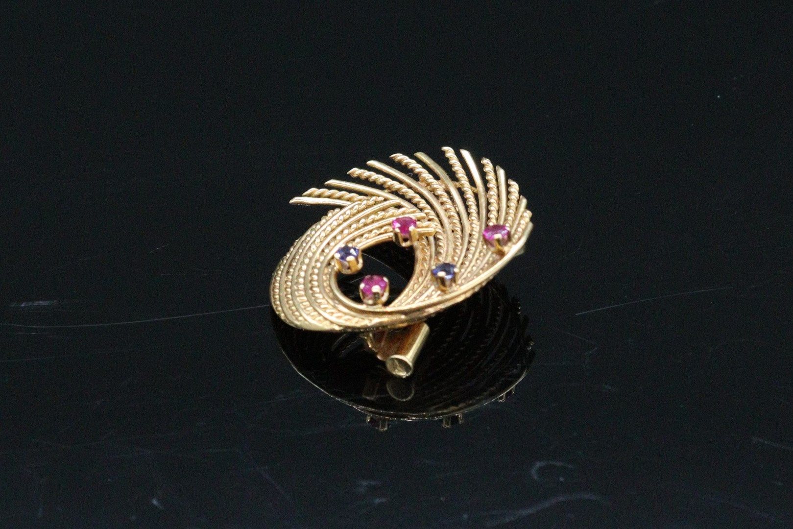 Null Brooch in 18K (750) yellow gold set with small rubies and synthetic sapphir&hellip;