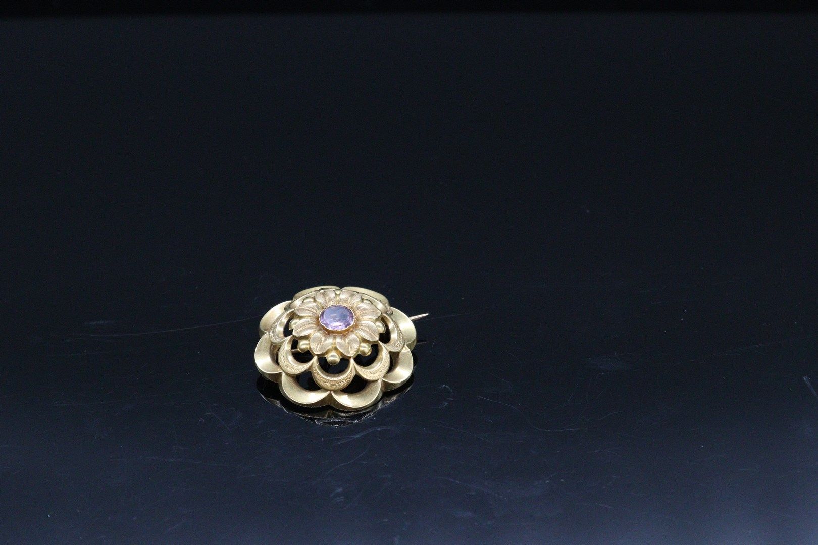 Null Broche en or jaune 18k (750) stylisant une fleur centré d'une améthyste ron&hellip;