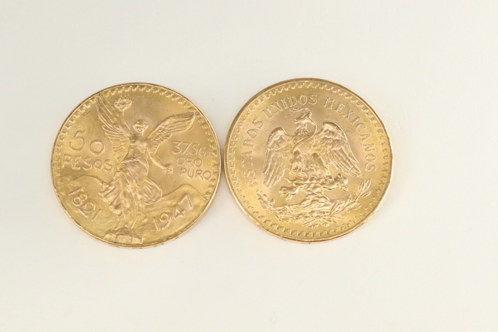 Null Lot of 2 gold coins of 50 pesos. 

Weight : 83.34 g.