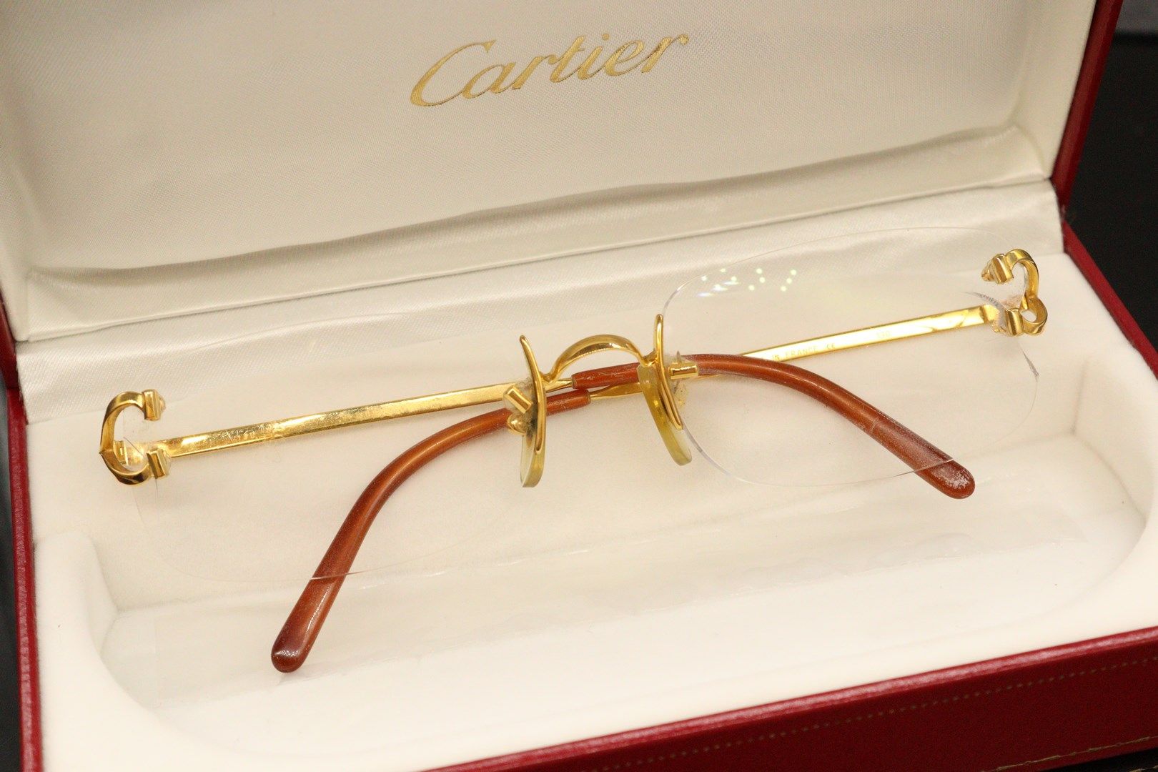 Null 
CARTIER




Gilded metal glasses frame, signed Cartier, in its original ca&hellip;