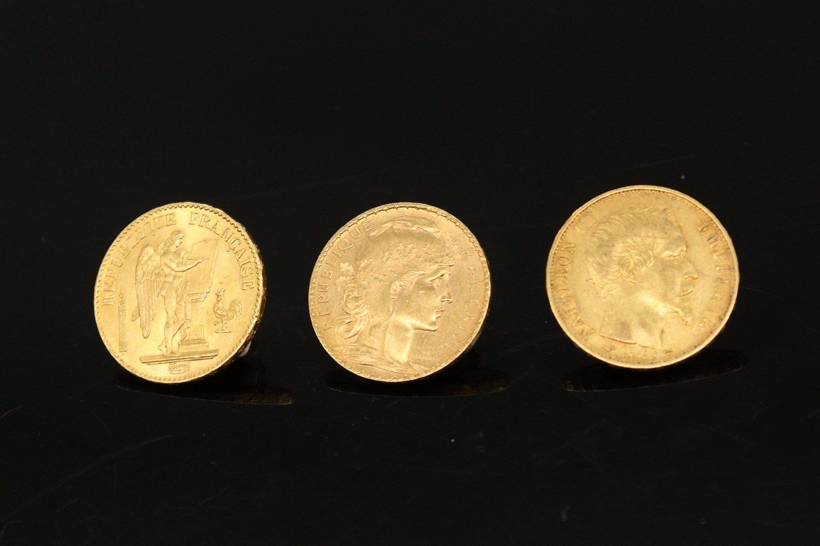 Null Three gold coins of 20 francs :

- Napoleon bareheaded 1860 A (workshop: Pa&hellip;