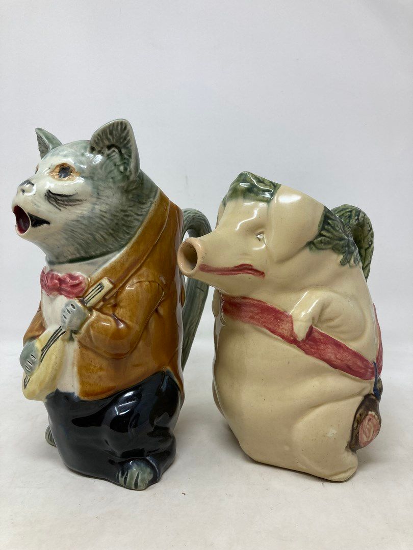 Null 兰花

拍卖会上有两只壶，分别是一只猪和一只穿棕色曼陀林外套的猫。

H.22和24厘米