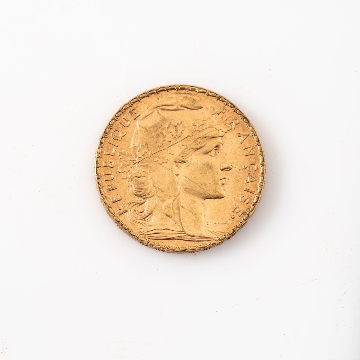 Null Une pièce en or de 20 Francs Coq (1909). 

Poids : 6,45 g.
