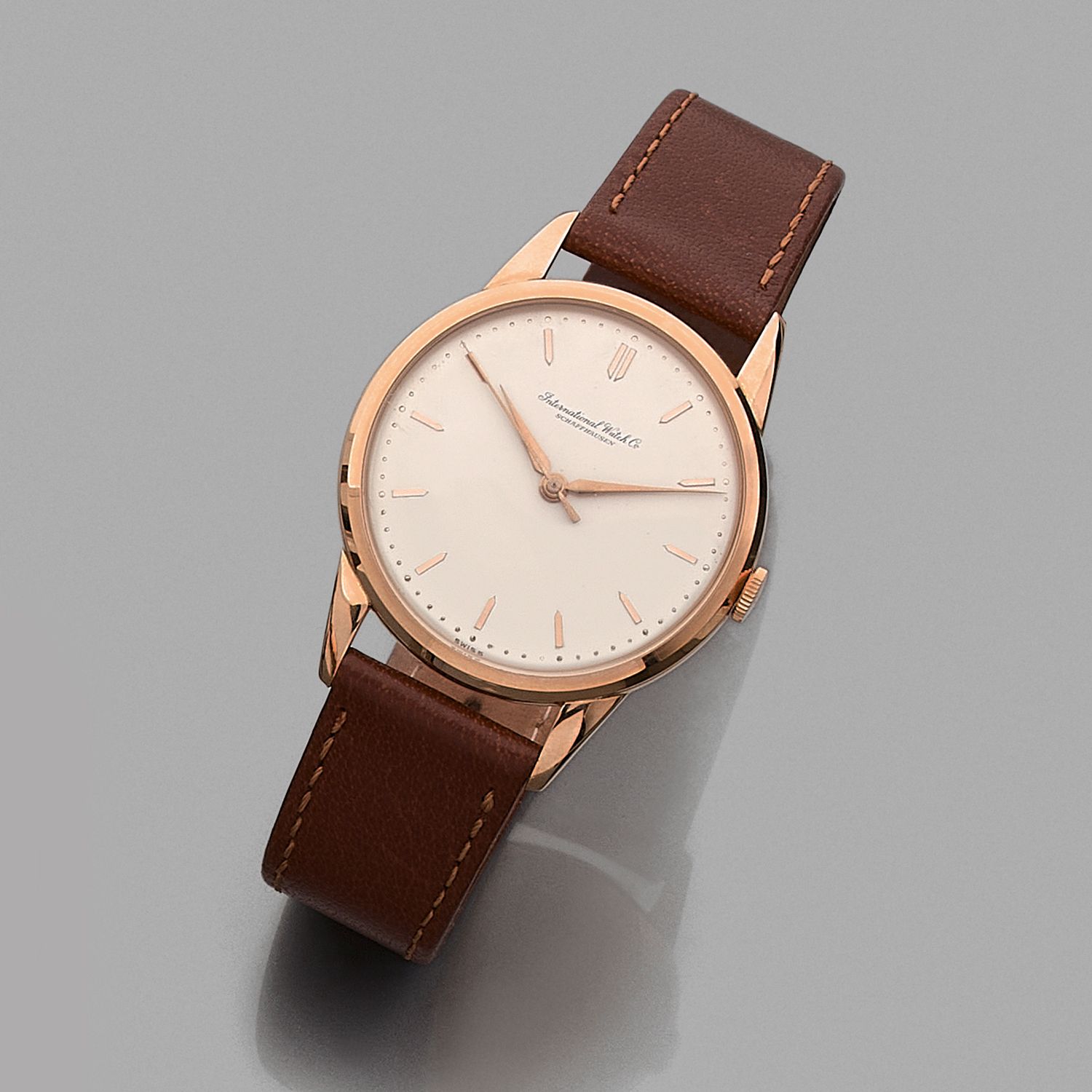 Null IWC
Circa 1960
18K rose gold bracelet watch on leather.
CASE: round. 
DIAL:&hellip;