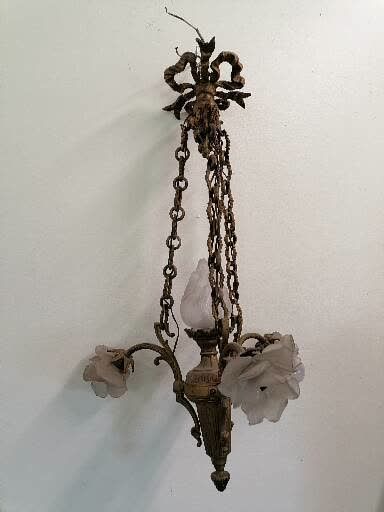 Null LUSTRE

青铜材质，有三个灯臂和一个火焰

20世纪

H.68厘米

附有一个带吊坠的小笼吊灯

高73厘米