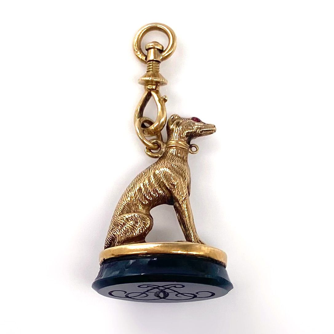 Null PENDANT holding a seal topped by a greyhound. The eyes are decorated with t&hellip;