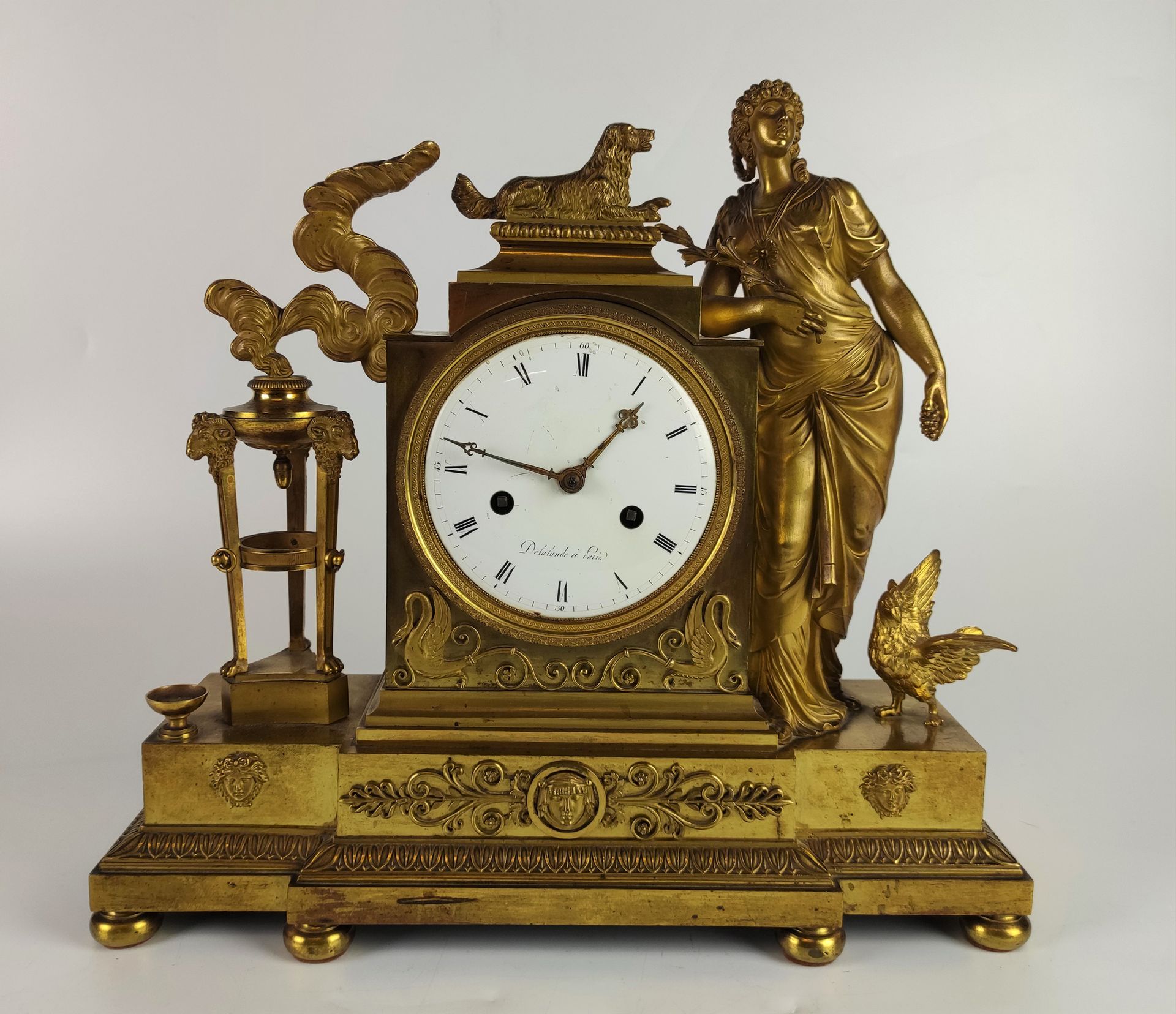 Null An ormolu and chased clock decorated with a vestal and her dog leaning on a&hellip;