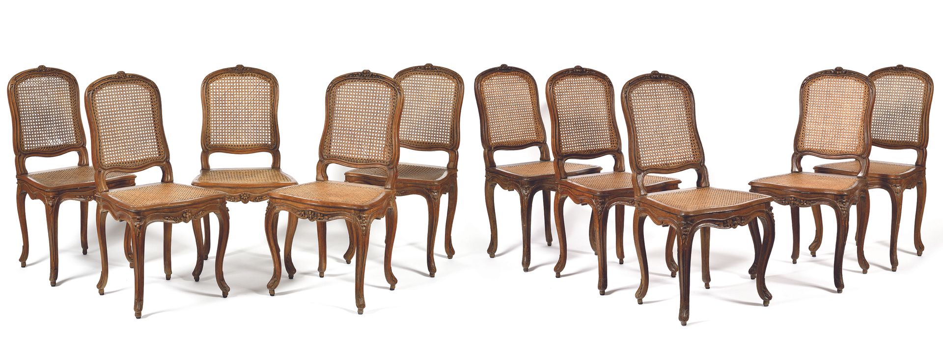 Null Suite of TEN CANNED CHAIRS in natural wood, moulded and carved with flowers&hellip;