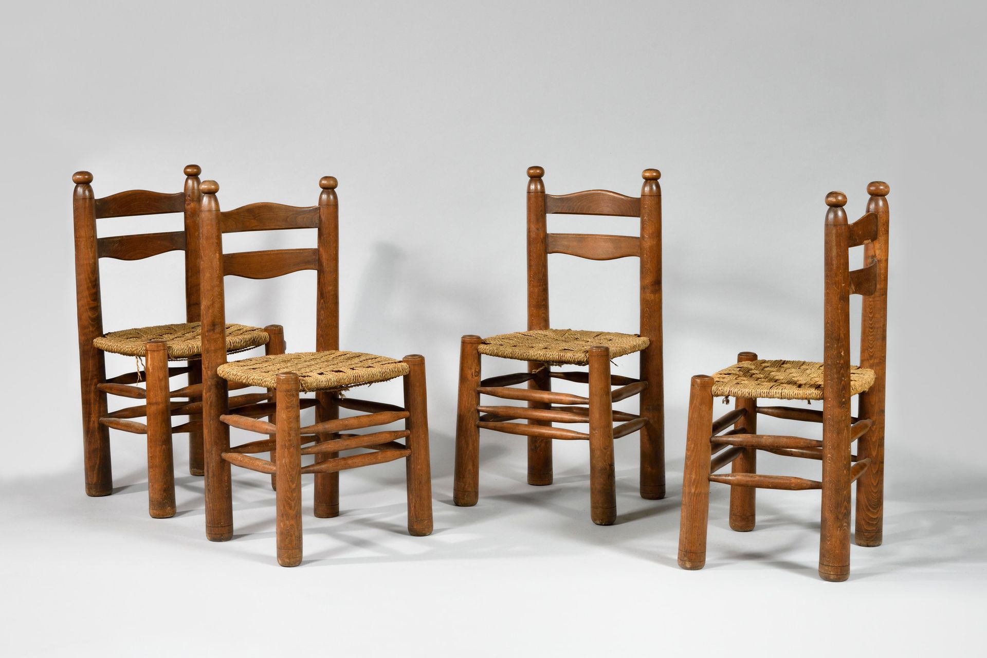 Null CHARLES DUDOUYT (1885-1946) Suite of four moulded oak chairs, rope seats He&hellip;