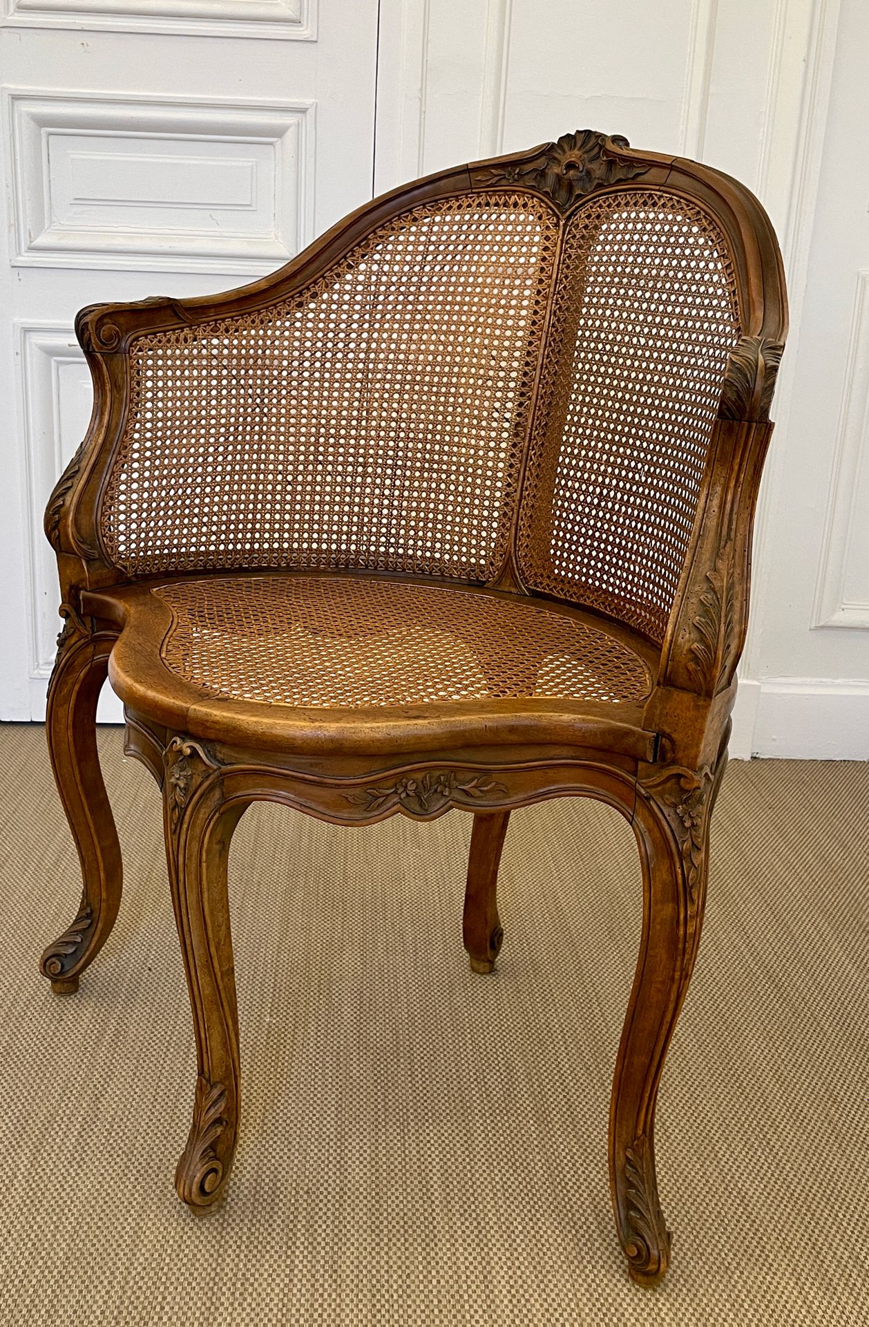 Null OFFICE CHAIR in molded and carved wood, seat and backrest caned, it rests o&hellip;